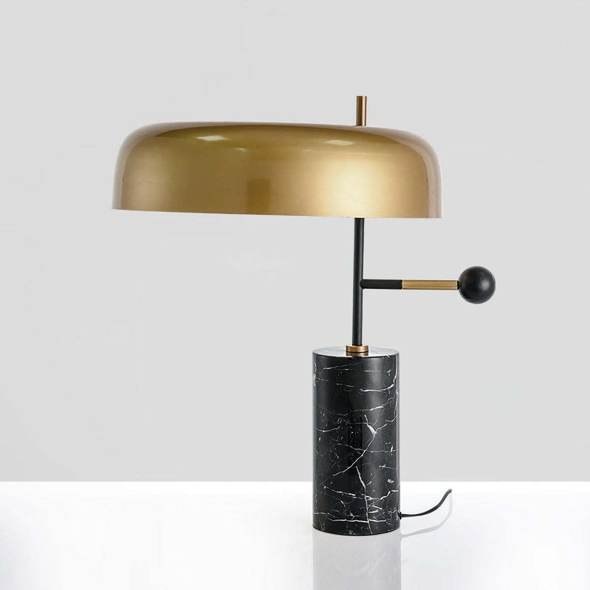 Barclay marble table lamp with gold dome shade on a grey background