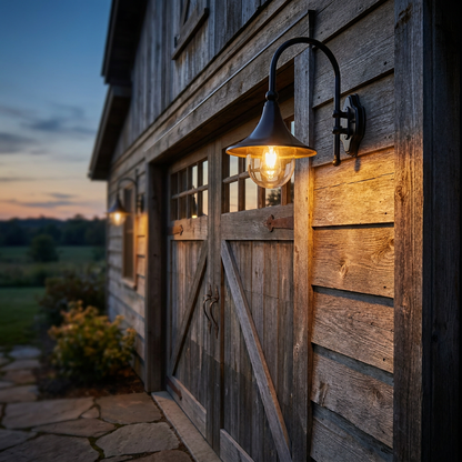 Trompette gooseneck lantern above a farmhouse barn garage at dusk