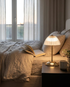 Elara brushed brass cordless table lamp on a bedroom nightstand
