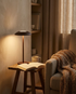 Vela brown contemporary LED table lamp in a reading nook