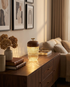 Calice walnut cup glass table lamp on a living room console