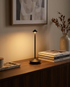 Pina black cordless mushroom-top table lamp on a living room console