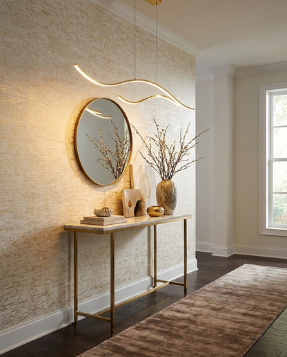 Ondeva gold curved wave pendant in an upscale entryway