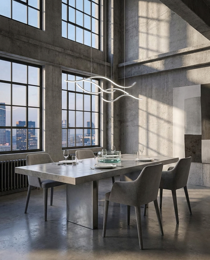 Ondeva chrome curved wave pendant over a loft dining area