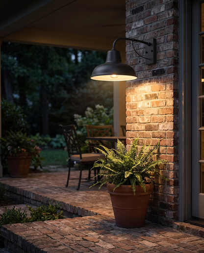 Ferro Barn Wall Sconce in Black beside a brick patio entryway
