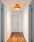 Cobre Glass Ceiling Light in Orange flush mounted in a hallway
