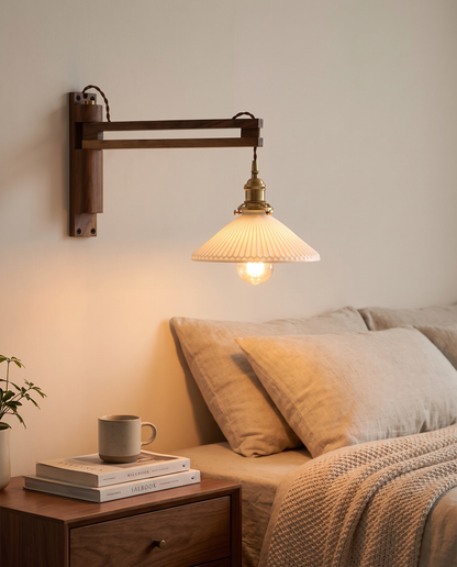 Bjork Glass Wall Sconce in Walnut in a bedroom