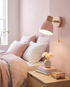 Sorbet Wall Sconce in Pink in a bedroom