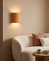 Momo Wall Sconce in Orange in a living room