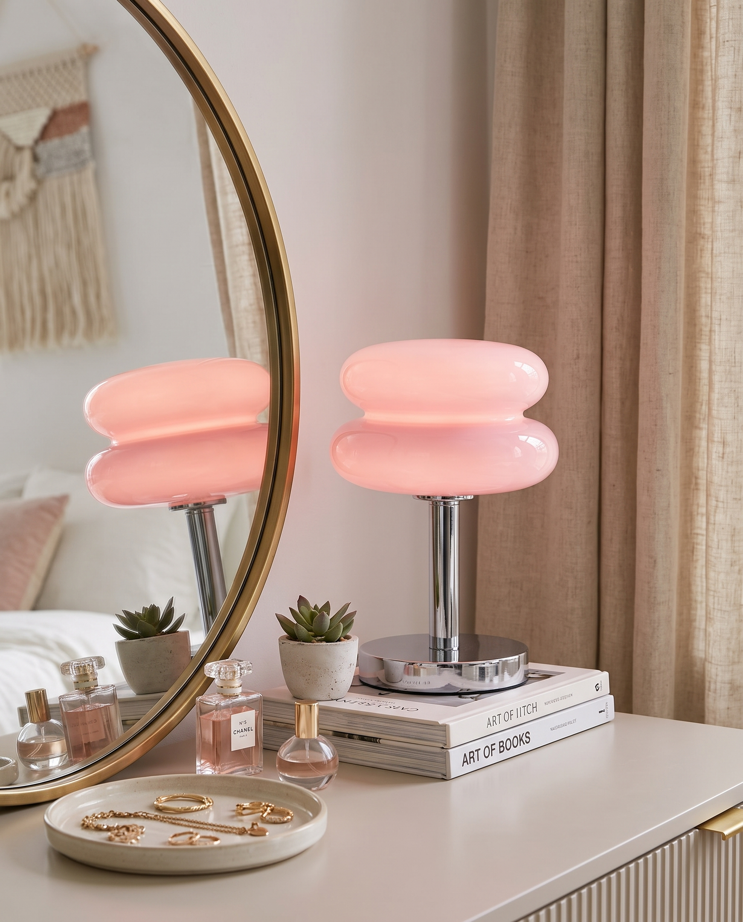 Tarta Table Lamp in Pink on a bedroom vanity beside a mirror