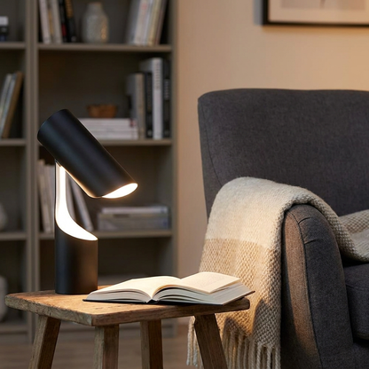 Cilindro Desk Lamp beside a reading armchair