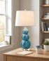 Juno lake blue ceramic gourd table lamp on a home office desk