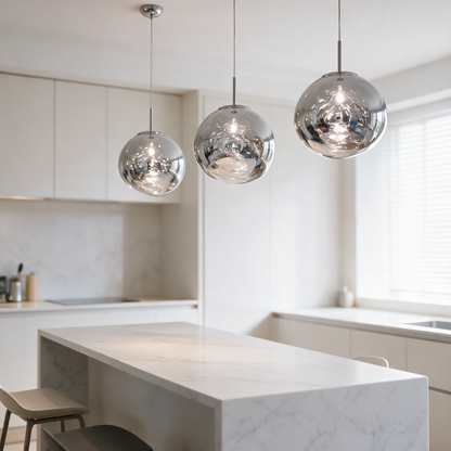 Drift Melt Glass Globe Pendant Light in Silver hanging as a trio above a white marble kitchen island