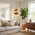 Orsini smoky gray glass orb pendant light in an open plan living space above a sideboard