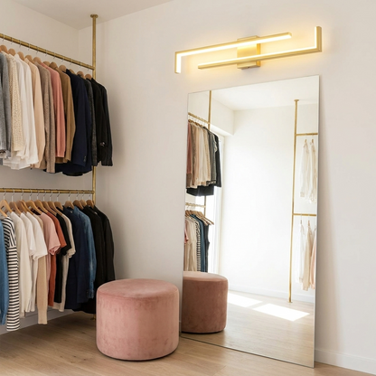 Ermont gold long bar wall light above a full length mirror in a dressing room