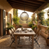 Girond black waterproof outdoor pendant light above an oak dining table on a patio terrace