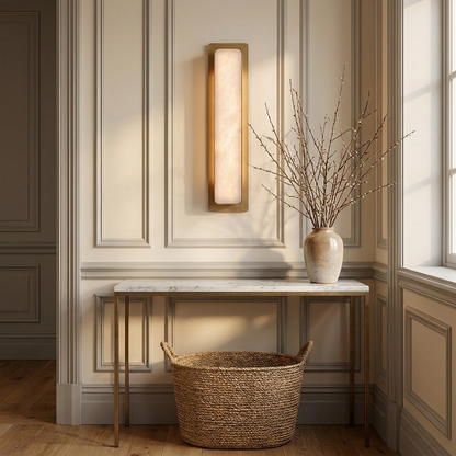 Vasari marble and gold wall light in a panelled entryway above a marble console