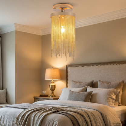 Odetta gold metal tassel chandelier in an elegant bedroom with linen headboard