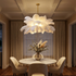 Plume white feather ceiling light above a round marble dining table