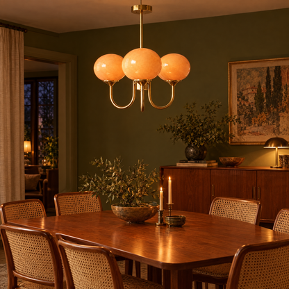 Mallow Glass Shade Chandelier in Copper and Orange above a teak dining table