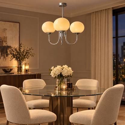 Mallow Glass Shade Chandelier in Chrome and Cream above a glass dining table