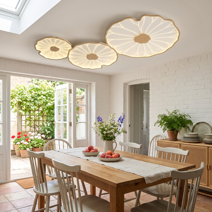 Nymphea three leaf natural wood ceiling light above a garden room dining table