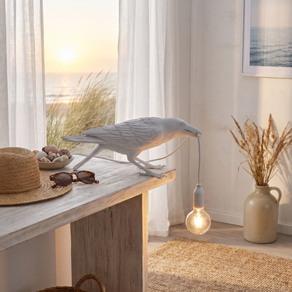 Corbeau white low raven table lamp in a coastal living room