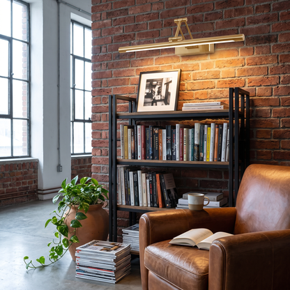 Brillan Model B gold LED picture light in an industrial loft reading corner