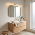 Lumio Gold & Warm Light linear plug-in wall lamp in a Japandi bathroom above the vanity mirror