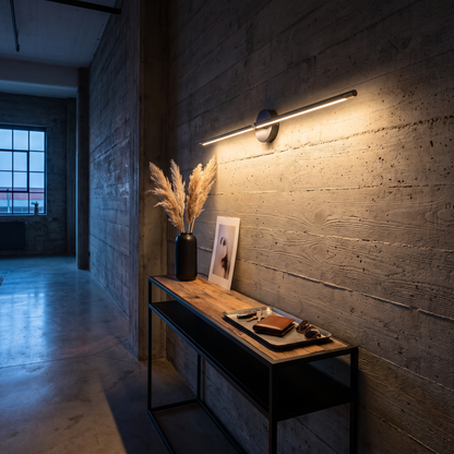 Arlen Black linear LED wall light above a console in an industrial loft hallway