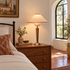 Talonwood table lamp in beige on a dresser in a Spanish Revival bedroom