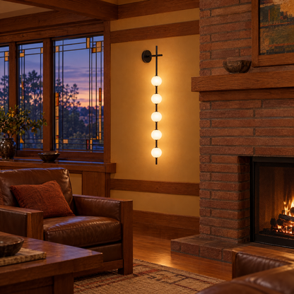Kaskade globe wall sconce in black with 5 small globes in a Prairie-style home living room
