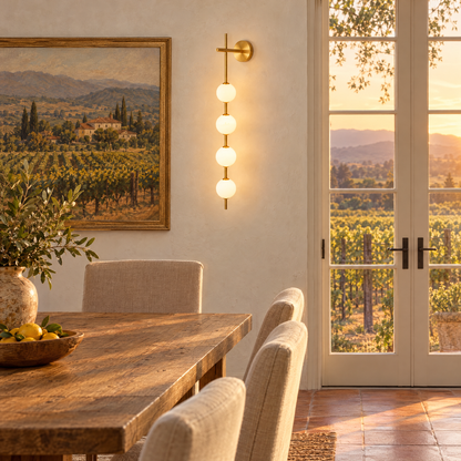Kaskade globe wall sconce in brass with 4 globes in a Napa Valley farmhouse dining room