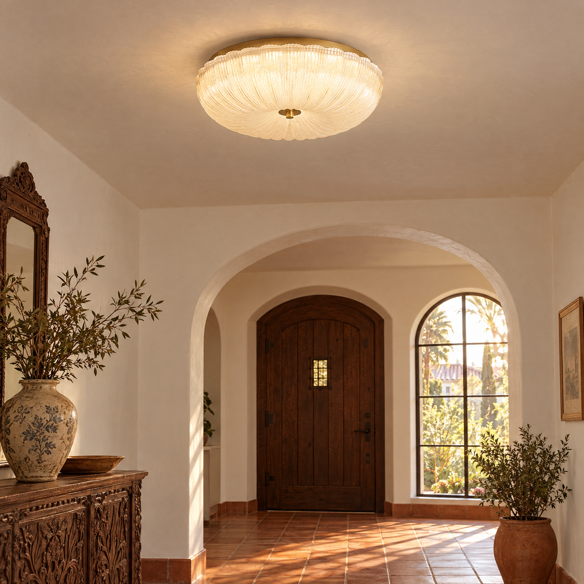 Givre ceiling light in frosted glass with gold trim in a California Spanish Revival entryway