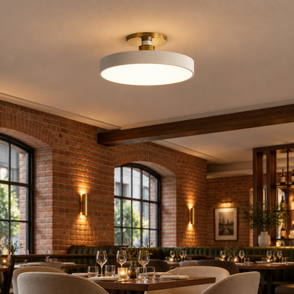Tuva Flush Mount LED Ceiling Light, White, in an upscale restaurant dining room in a renovated brick building