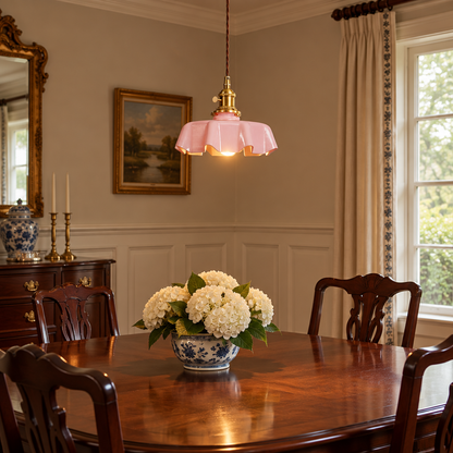 Hyacinth Pleated Glass Pendant Light, 1 Light Brass and Pink, in a colonial style dining room with wainscoting and a mahogany table