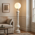Corinthe ivory white floor lamp in the corner of a transitional American living room beside a linen sofa