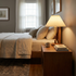 Elodie table lamp on a nightstand beside a bed in a transitional suburban bedroom