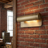 Albane 10 inch wall sconce on a brick wall of a downtown loft apartment