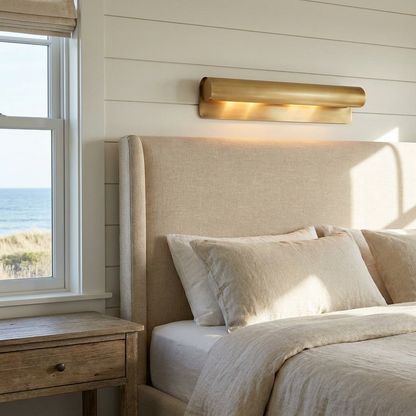 Albane 19.7 inch wall sconce beside an upholstered headboard in a coastal New England bedroom