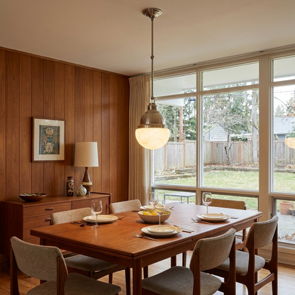 Gisele nickel pendant light above the dining table of a mid-century ranch home