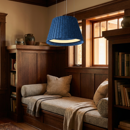 Calma blue pendant light above a reading nook bench in a craftsman bungalow