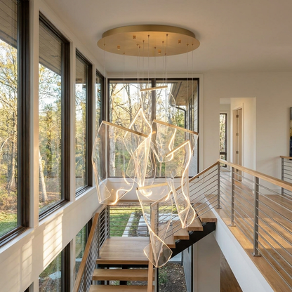Cirrane 6 heads gold chandelier in the stairwell of a contemporary house with floor-to-ceiling windows