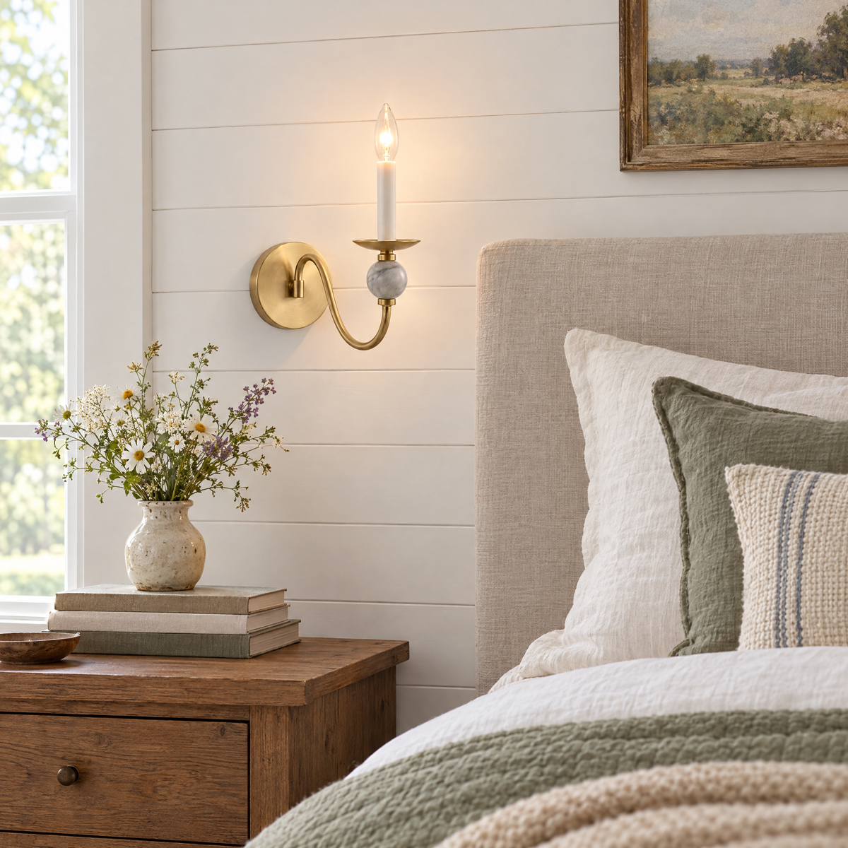 Brisa marble ball wall sconce in Brushed Brass beside a farmhouse bed