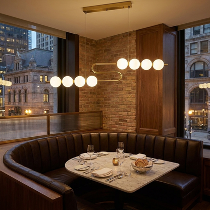 Coralyn LED chandelier over a booth in an upscale restaurant