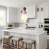 Trilla three ball acrylic pendant light over a kitchen island in a suburban home