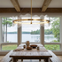 Rivage round LED chandelier over a dining table in a lake house