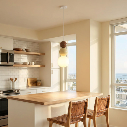 Trilla three ball acrylic pendant light over a kitchen peninsula in a condo
