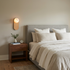 Corisande Alabaster Wall Sconce in Copper & White beside a bed in a primary bedroom