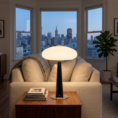 Quintia fluted glass rechargeable LED table lamp on a side table beside an apartment sofa